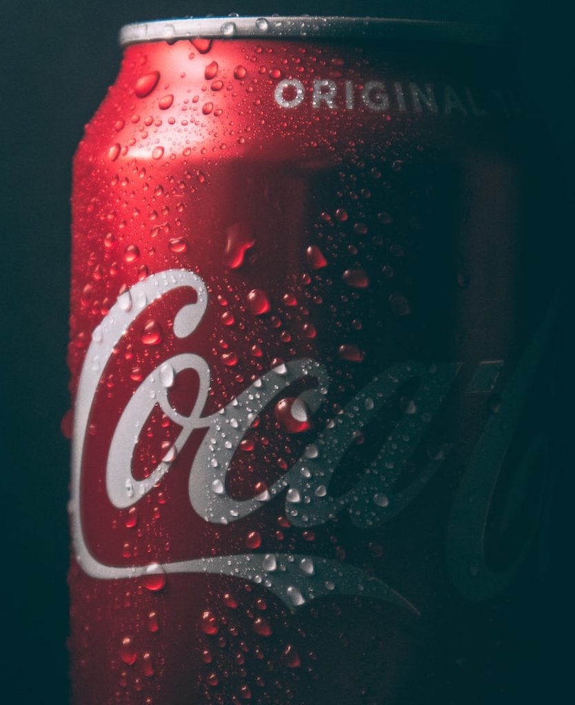 coca cola can on black surface